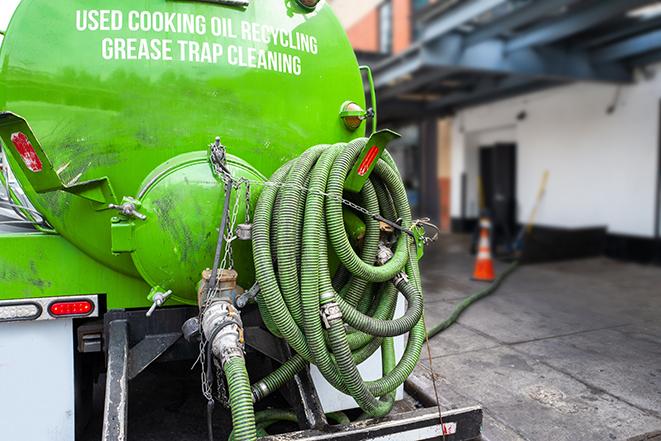 pump truck removing waste from a grease trap in Delmar